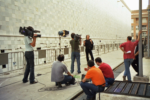 Joey Skaggs interviewed by local media outside EACC Museum during his exhibition, October 2002